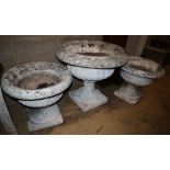 Three reconstituted stone campana garden urns, largest 70cm diameter, H.62cm