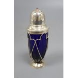 An Edwardian Arts and Crafts silver and gem set mounted blue glass sugar shaker, no maker's mark,