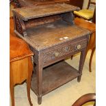 A late 19th century carved oak two tier table, fitted one drawer, W.72cm