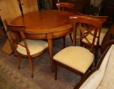 A modern cherrywood 'D' ended extending dining table and a set of four chairs, table diameter 116cm