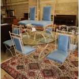 An enamelled metal dining suite comprising a circular glass-topped table and a set of eight