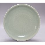 A Chinese celadon glazed dish, 18th / 19th century, Qianlong mark, diameter 28cmCONDITION: There are