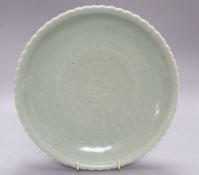 A Chinese celadon glazed dish, 18th / 19th century, Qianlong mark, diameter 28cmCONDITION: There are
