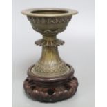 A 19th century Himalayan bronze urn, on carved stand, height 18cm