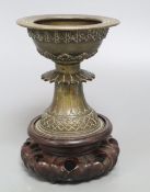 A 19th century Himalayan bronze urn, on carved stand, height 18cm