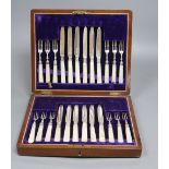 A cased set of twelve mother of pearl handled silver deseert knives and eleven forks, F. Asman & Co,