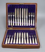 A cased set of twelve mother of pearl handled silver deseert knives and eleven forks, F. Asman & Co,