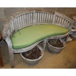 A weathered teak garden banana bench with cushion, W.160cm, D.60cm, H.85cm