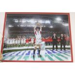 A signed photograph of Martin Johnson lifting the rugby world cup 2003, 38 x 49cm