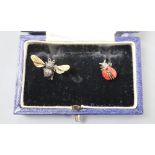 A pair of asymmetric white and yellow metal ladybird and bee earrings.