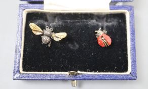 A pair of asymmetric white and yellow metal ladybird and bee earrings.