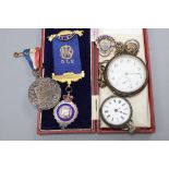 Two silver pocket watches, a silver buffalo medallion, coronation medal etc.