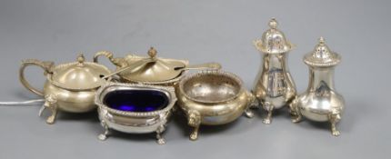 Two 20th century silver three piece condiment sets, including one by Lowe & Son.