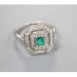 An Art Deco white metal, emerald and diamond set octagonal tablet ring, (emerald chipped), size J/K,