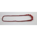 A single strand graduated simulated cherry amber oval bead necklace, 69cm, gross 54 grams.