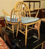 An Ercol beech armchair, together with an Ercol beech elbow chair