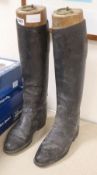 A pair of black leather riding boots and Maxwell of London trees