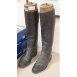 A pair of black leather riding boots and Maxwell of London trees