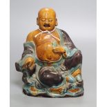 A Chinese Sancai pottery figure of a Budai, 18th/19th century, height 20cmCONDITION: This has at
