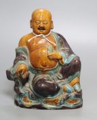 A Chinese Sancai pottery figure of a Budai, 18th/19th century, height 20cmCONDITION: This has at