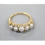 A Victorian yellow metal, graduated split pearl and diamond chip set half hoop ring, size R, gross