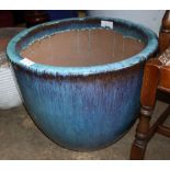 A large turquoise glazed garden planter, 57cm diameter