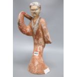 A Chinese painted pottery figure of a dancer, Han dynasty or later, height 45cm