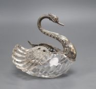 A cut glass pot pourri, in the form of a swan with embossed silver head and pierced hinged wings,
