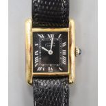 A lady's 925 gilt Must De Cartier manual wind wrist watch, with rectangular black Roman dial, on