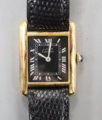 A lady's 925 gilt Must De Cartier manual wind wrist watch, with rectangular black Roman dial, on