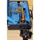 A Yamaha trumpet and a cased camera