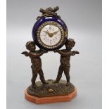 A French porcelain and bronze putti mantel clock, with diamonte decoration to the dial, height 20cm