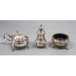 A silver three piece cruet set, with embossed girdle, on three hoof feet, blue glass liners,