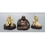 A Chinese bronze figure of a Budai and two Japanese carved ivory figures on stand