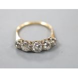 An early 20th century yellow metal and graduated five stone old cut diamond ring, size R, gross 3