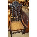 A pair of late 19th century Flemish carved oak cane seat elbow chairs, W.60cm, D.57cm, H.126cm