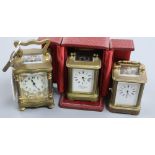 A cased lacquered brass miniature carriage timepiece and two others