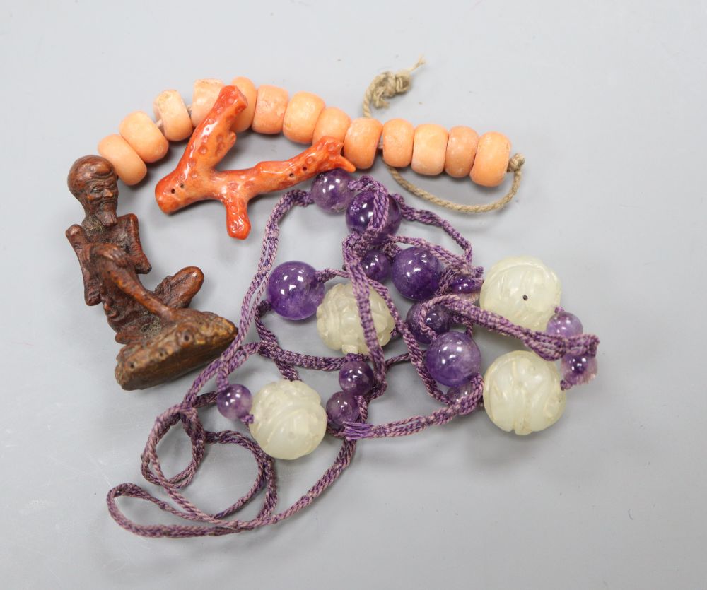 A bamboo carving of a luohan, a jade necklace and mixed coral