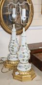 A pair of German porcelain Schneeballen floral encrusted table lamps, on carved giltwood bases