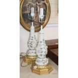 A pair of German porcelain Schneeballen floral encrusted table lamps, on carved giltwood bases