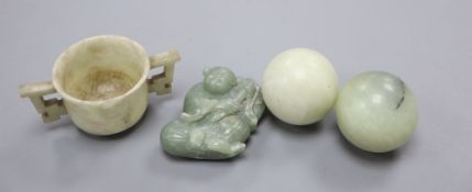 Four Chinese hardstone carvings, one of a gent, a cup and two balls