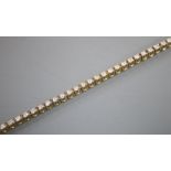 A modern 9ct gold and diamond set line bracelet, 17.7cm, gross 7 grams, approx. weight of each stone