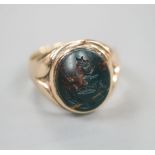 A 9ct and carved crested oval bloodstone set signet ring (stone a.f.), size K, gross 4.5 grams.