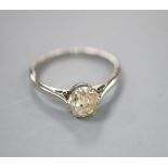 A white metal (stamped platinum) and diamond solitaire ring, size L, gross 2.4 grams.CONDITION: