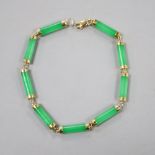 A 585 yellow metal mounted jadeite bracelet, 19cm, gross 6.6 grams.CONDITION: Overall condition of