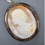 A Victorian 15ct mounted oval cameo shell pendant brooch, carved with the figure of Diana?,