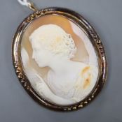 A Victorian 15ct mounted oval cameo shell pendant brooch, carved with the figure of Diana?,