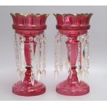 A pair of cranberry glass lustres, late 19th century, height 34cm