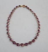 A Victorian pinchbeck and graduated amethyst coloured paste set necklace, 45.2cm, lacking central