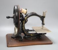 A Victorian Wilcox and Gibb sewing machine and wooden case